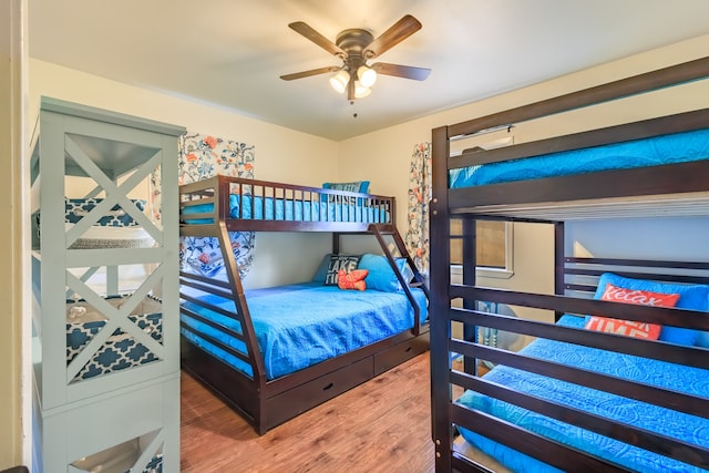 bedroom with ceiling fan and hardwood / wood-style flooring