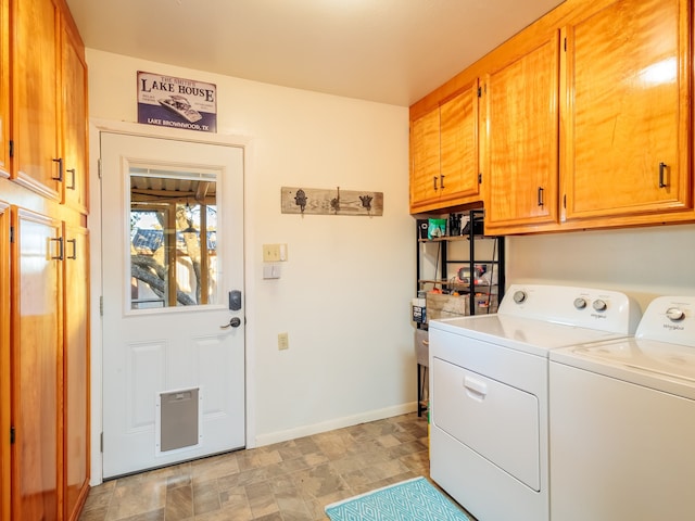 laundry room featuring washing machine and clothes dryer and cabinets