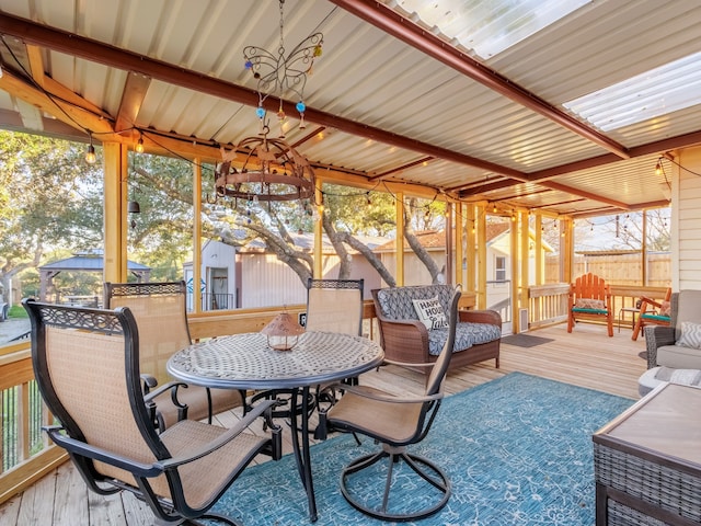 sunroom / solarium featuring a chandelier and a healthy amount of sunlight