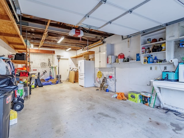 garage featuring a garage door opener and white fridge