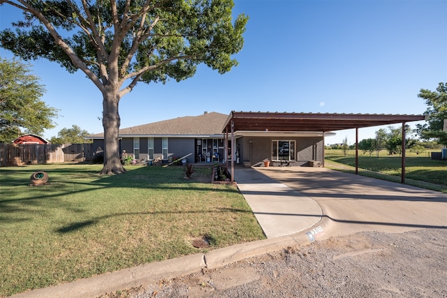 view of front of property with a front yard and a carport