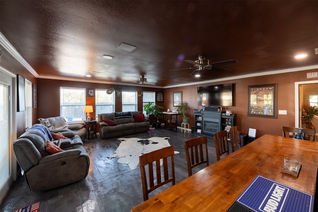 dining room with a textured ceiling, crown molding, and ceiling fan