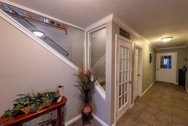 corridor featuring ornamental molding and dark tile patterned floors