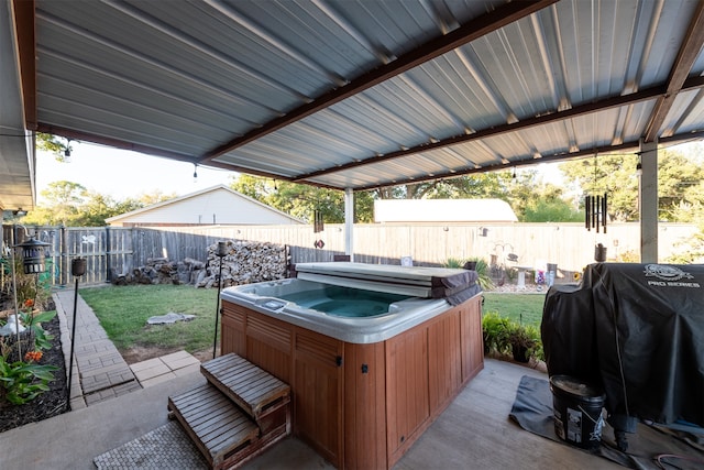 view of patio with a hot tub and a grill