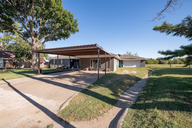 view of front of property with a front yard and a garage