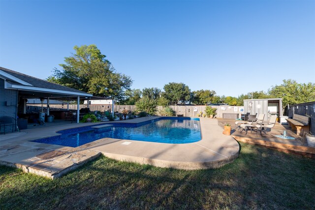 view of pool featuring a yard and a patio