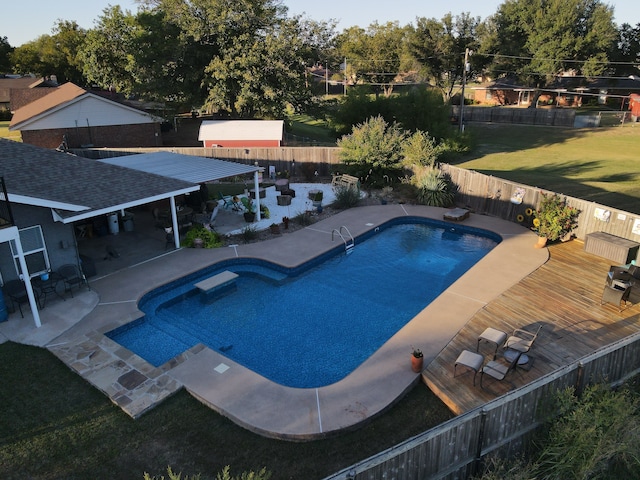 view of swimming pool with a patio, a diving board, and a yard