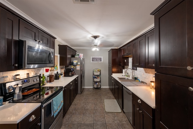 kitchen with dark brown cabinetry, sink, ornamental molding, backsplash, and appliances with stainless steel finishes