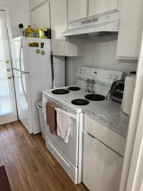 kitchen with light stone countertops, dark hardwood / wood-style flooring, white appliances, and white cabinetry