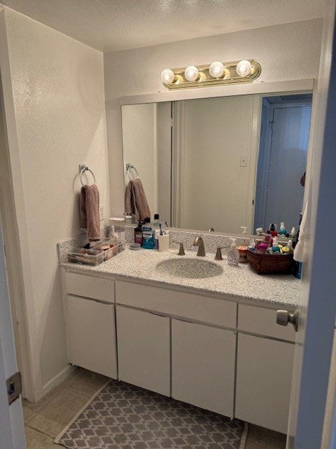 bathroom featuring tile patterned flooring and vanity