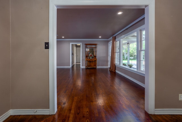 interior space with ornamental molding and dark wood-type flooring