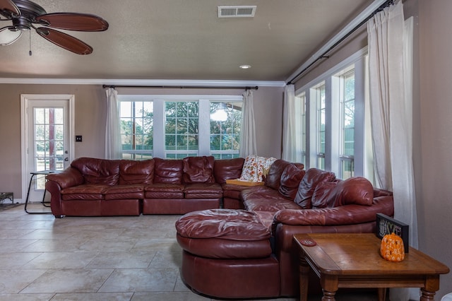 living room with ceiling fan and ornamental molding