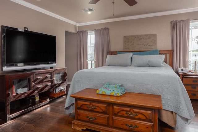 bedroom with ceiling fan, ornamental molding, dark wood-type flooring, and multiple windows