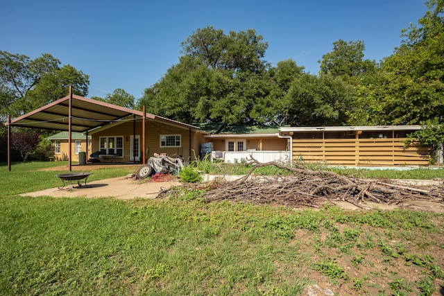 back of property featuring a lawn and a patio