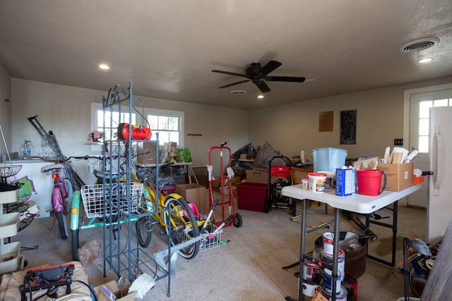 garage with ceiling fan and white fridge