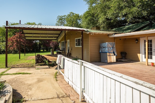 view of side of property featuring a yard and a patio area