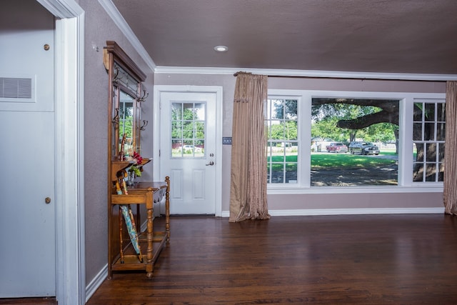 doorway featuring a textured ceiling, dark hardwood / wood-style floors, and ornamental molding