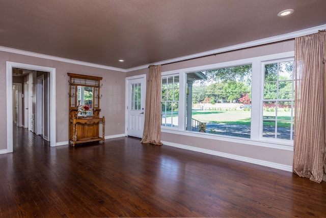 unfurnished living room with dark hardwood / wood-style floors, a healthy amount of sunlight, and crown molding