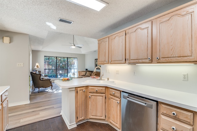 kitchen with sink, kitchen peninsula, dark wood-type flooring, dishwasher, and light brown cabinetry