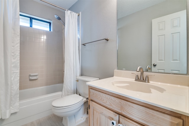 full bathroom featuring shower / bath combo, a textured ceiling, hardwood / wood-style flooring, vanity, and toilet