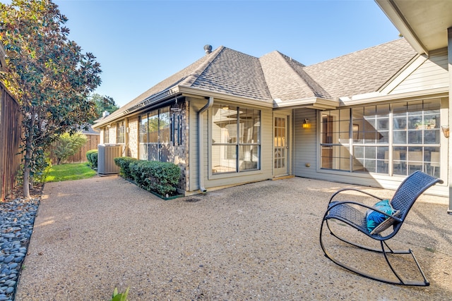 back of house featuring a sunroom, a patio, and central AC unit