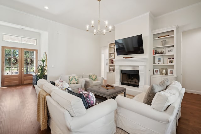 living room featuring french doors, an inviting chandelier, crown molding, and dark wood-type flooring