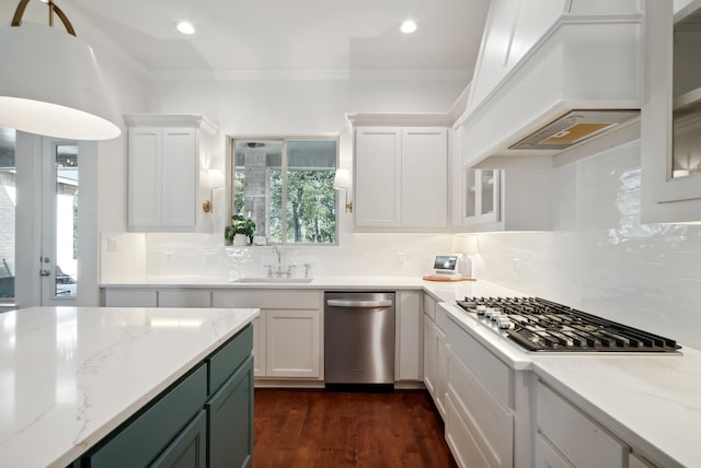 kitchen with a wealth of natural light, white cabinetry, appliances with stainless steel finishes, and sink