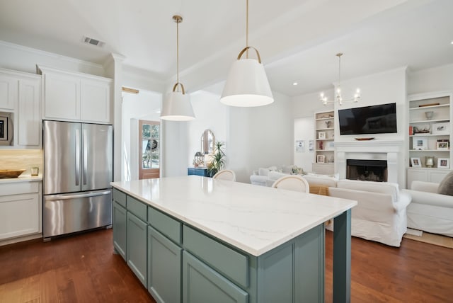 kitchen featuring dark hardwood / wood-style floors, white cabinetry, a kitchen island, appliances with stainless steel finishes, and decorative light fixtures