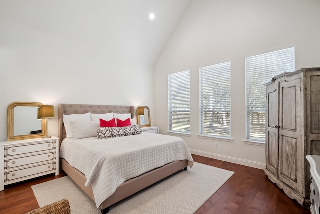 bedroom with high vaulted ceiling, multiple windows, and dark hardwood / wood-style flooring