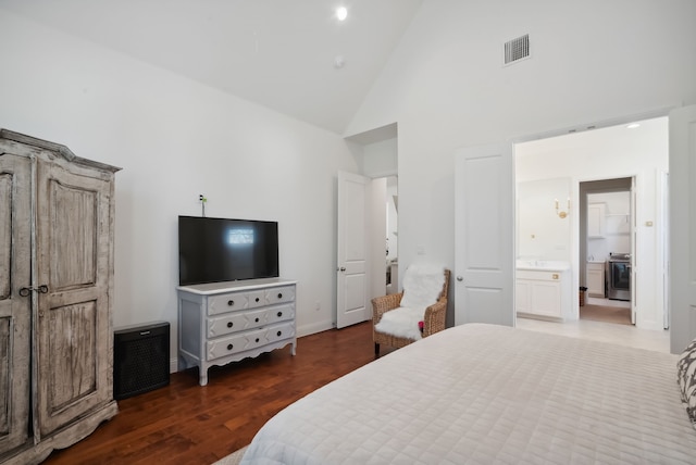 bedroom featuring dark hardwood / wood-style floors, ensuite bathroom, and high vaulted ceiling