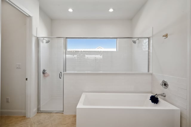 bathroom with separate shower and tub and tile patterned flooring