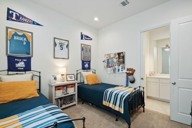 carpeted bedroom featuring ensuite bathroom