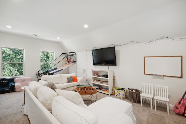 living room with vaulted ceiling and light carpet