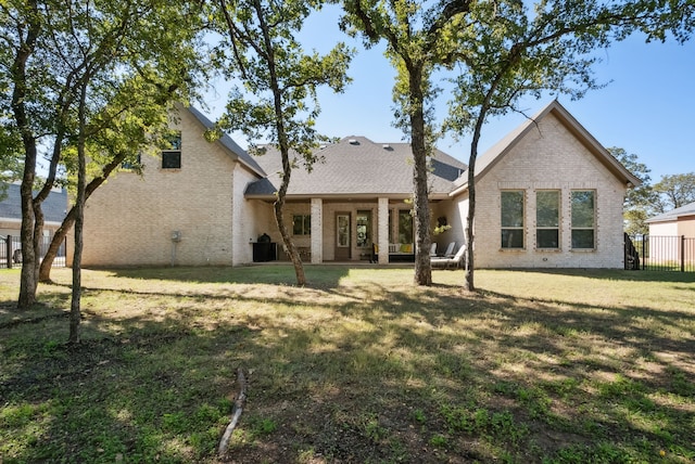 back of house with a lawn