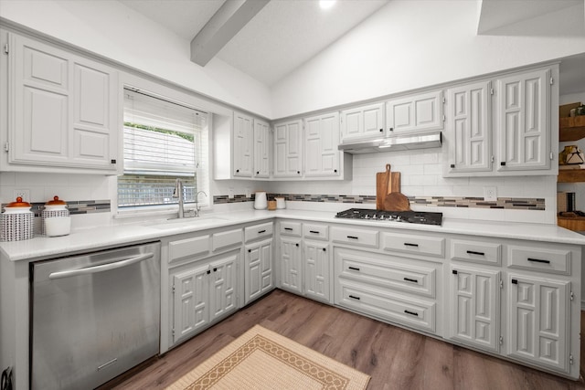 kitchen featuring tasteful backsplash, gas cooktop, dishwasher, vaulted ceiling with beams, and dark hardwood / wood-style floors