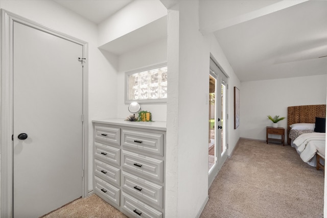 carpeted bedroom featuring vaulted ceiling and access to exterior