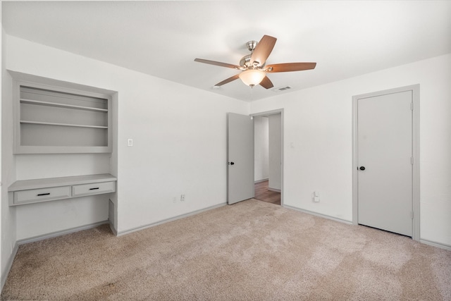 unfurnished bedroom featuring ceiling fan and light colored carpet