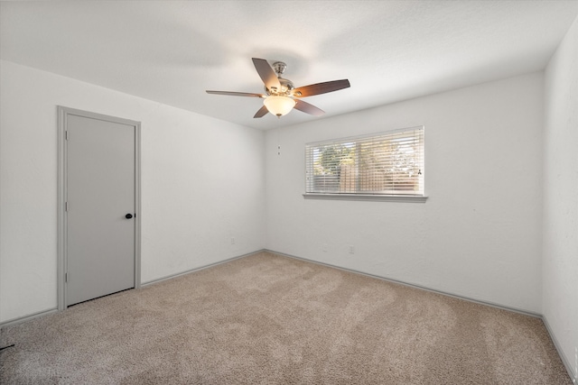 unfurnished room featuring ceiling fan and light colored carpet