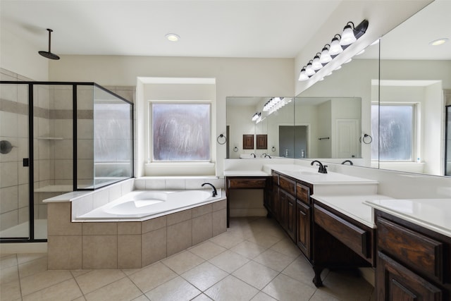 bathroom with vanity, shower with separate bathtub, and tile patterned flooring