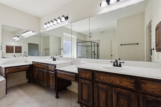 bathroom featuring tile patterned flooring, an enclosed shower, and vanity