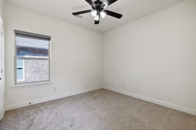 carpeted spare room with ceiling fan