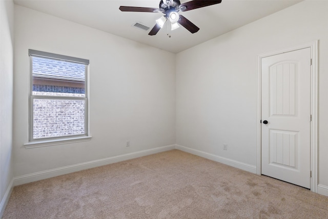 carpeted spare room with ceiling fan