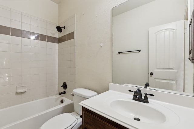 full bathroom featuring tiled shower / bath combo, vanity, and toilet