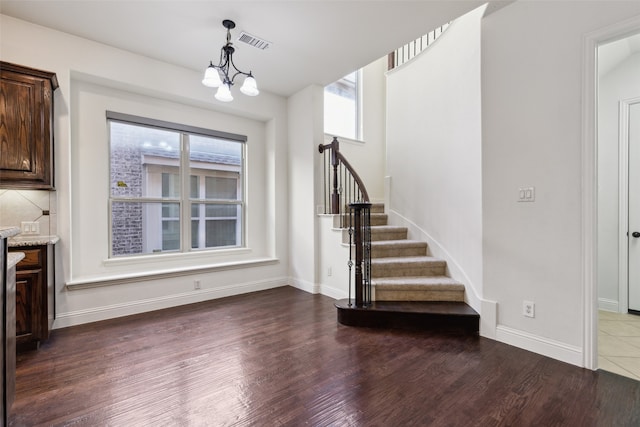 interior space with dark hardwood / wood-style floors and a chandelier