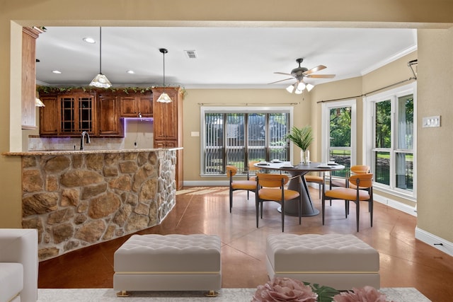 dining space featuring ceiling fan, light tile patterned floors, and crown molding