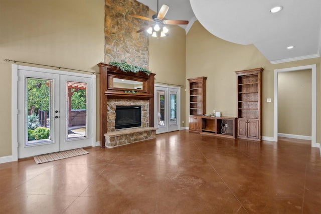 unfurnished living room featuring french doors, a fireplace, crown molding, and ceiling fan