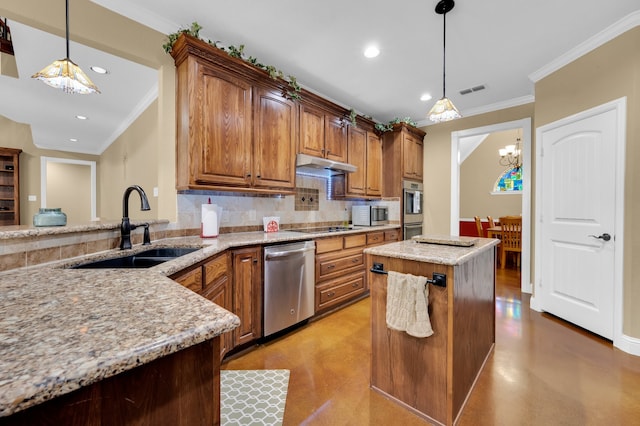 kitchen with appliances with stainless steel finishes, hanging light fixtures, light stone counters, a kitchen island, and sink