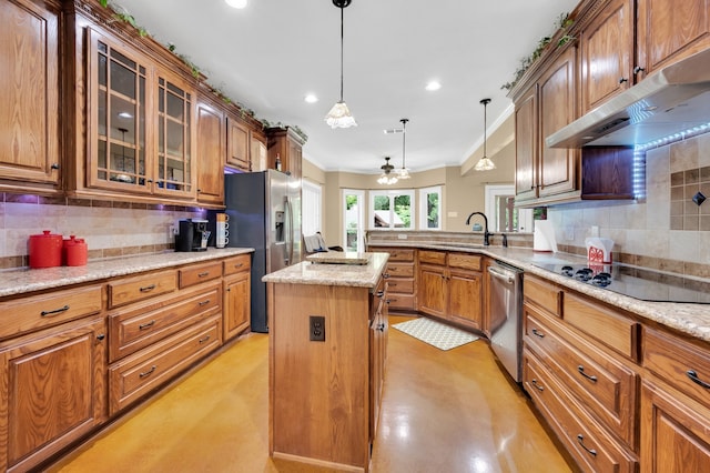 kitchen with decorative backsplash, light stone countertops, pendant lighting, stainless steel appliances, and a center island