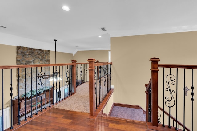 stairway featuring crown molding and hardwood / wood-style floors