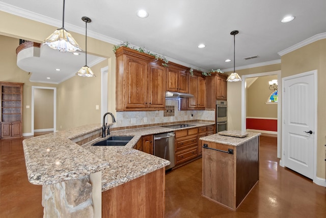 kitchen with appliances with stainless steel finishes, tasteful backsplash, a kitchen island, pendant lighting, and sink